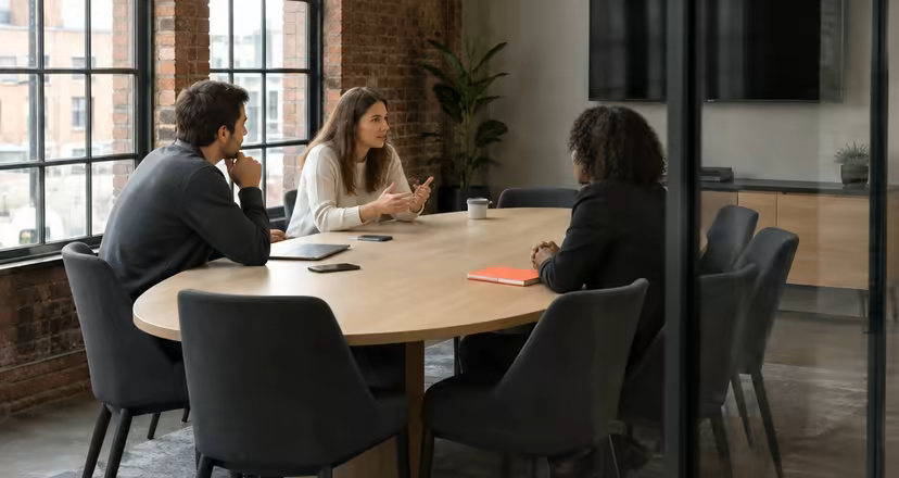 A meeting room with an oval oak table at Loft Nine.