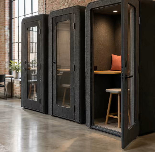A phone booth with its door open on the ground floor at Loft Nine.