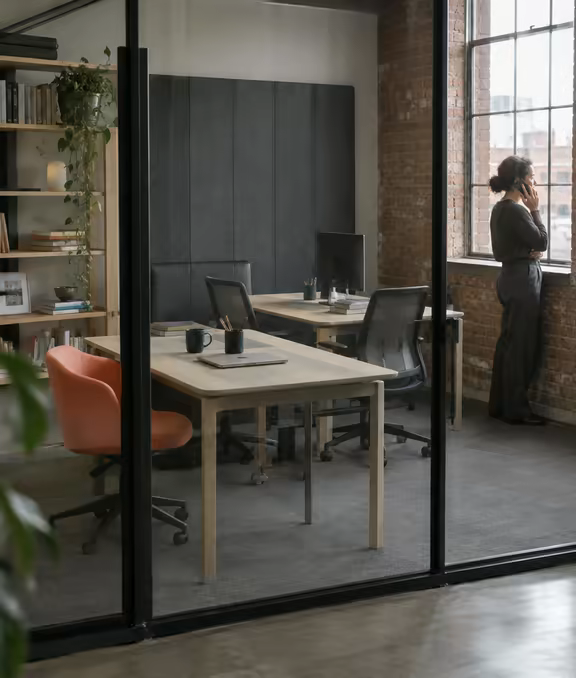 A private office behind a glass partition at Loft Nine.